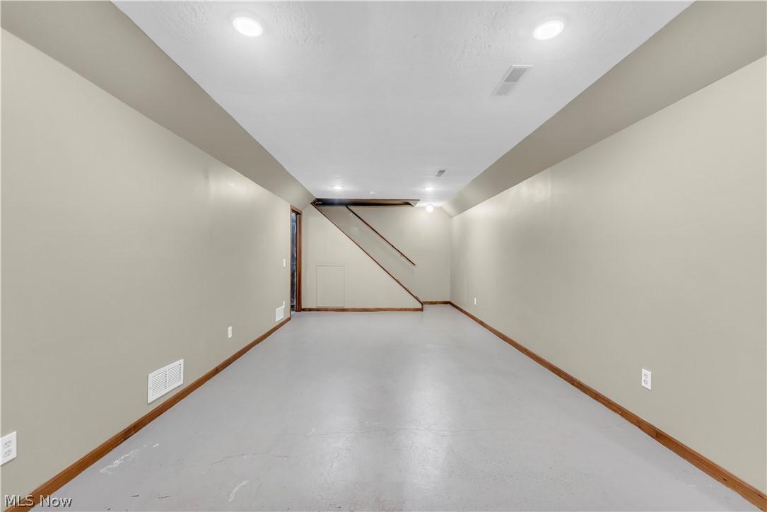 408 River Road Canal Fulton, OH 44614 - Photo 32 of 42 Finished lower level featuring recessed lighting, painted walls, wood-finish baseboards, and painted concrete flooring