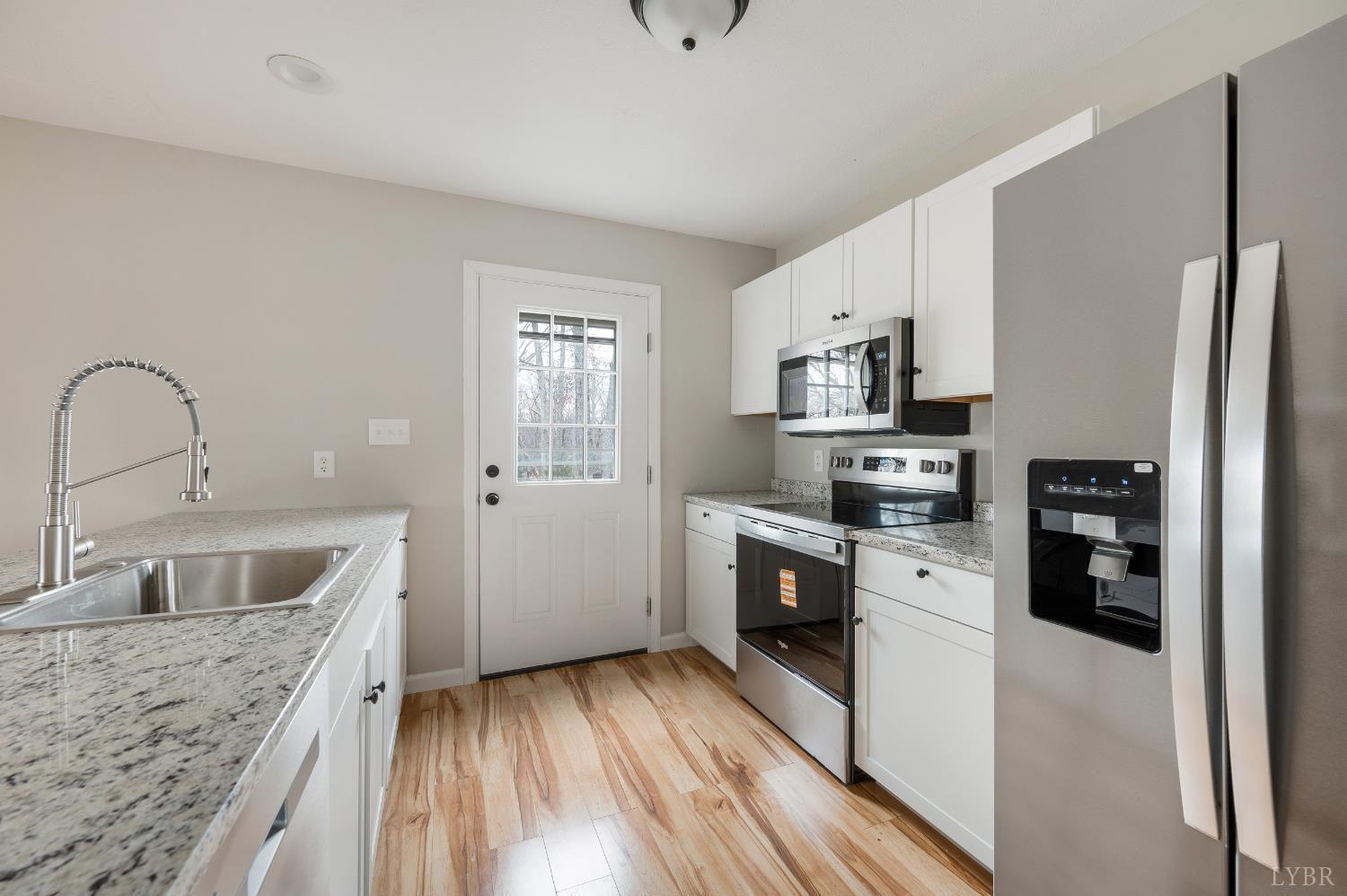 2365 Police Tower Road Appomattox, VA 24522 - Photo 13 of 52 a kitchen with stainless steel appliances granite countertop a sink stove and refrigerator