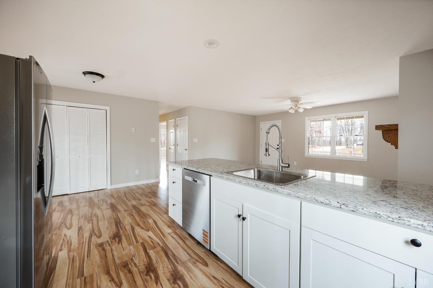 2365 Police Tower Road Appomattox, VA 24522 - Photo 14 of 52 a kitchen with granite countertop a sink cabinets and wooden floor