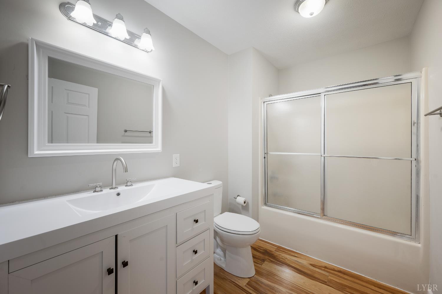 2365 Police Tower Road Appomattox, VA 24522 - Photo 20 of 52 a bathroom with a toilet a sink a mirror and a shower