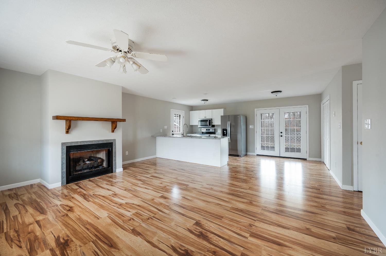 2365 Police Tower Road Appomattox, VA 24522 - Photo 6 of 52 a view of empty room with wooden floor and fireplace