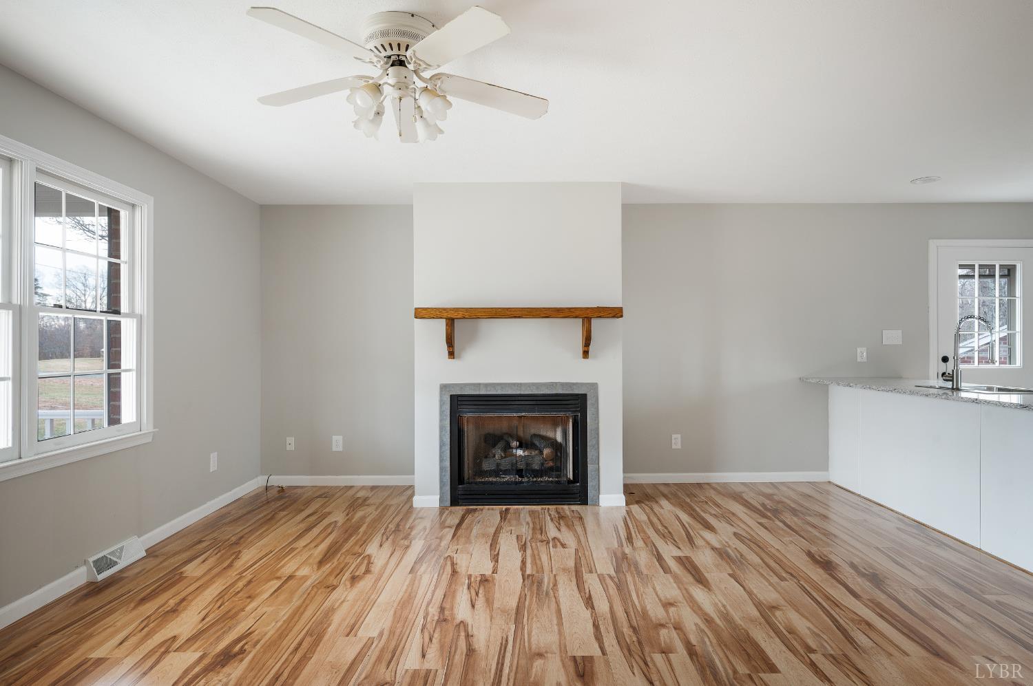 2365 Police Tower Road Appomattox, VA 24522 - Photo 8 of 52 wooden floor fireplace and window in an empty room