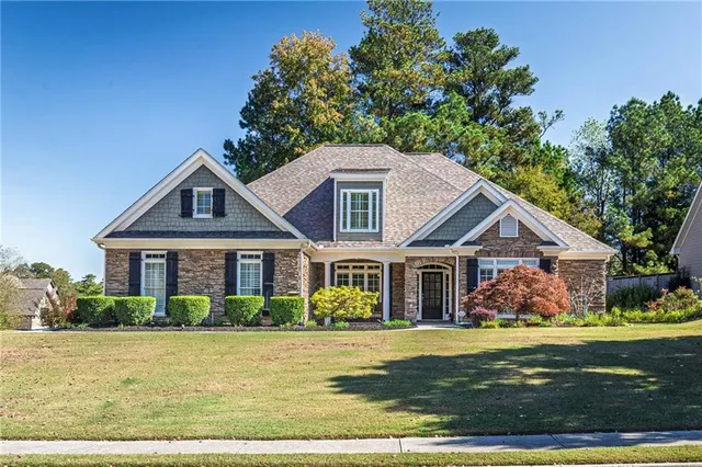 a front view of a house with garden
