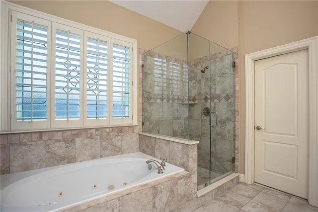 a bathroom with a bathtub and shower