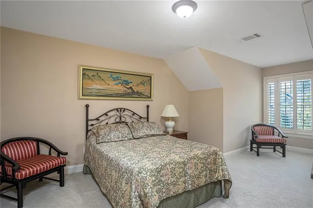 a bedroom with a bed and a couch