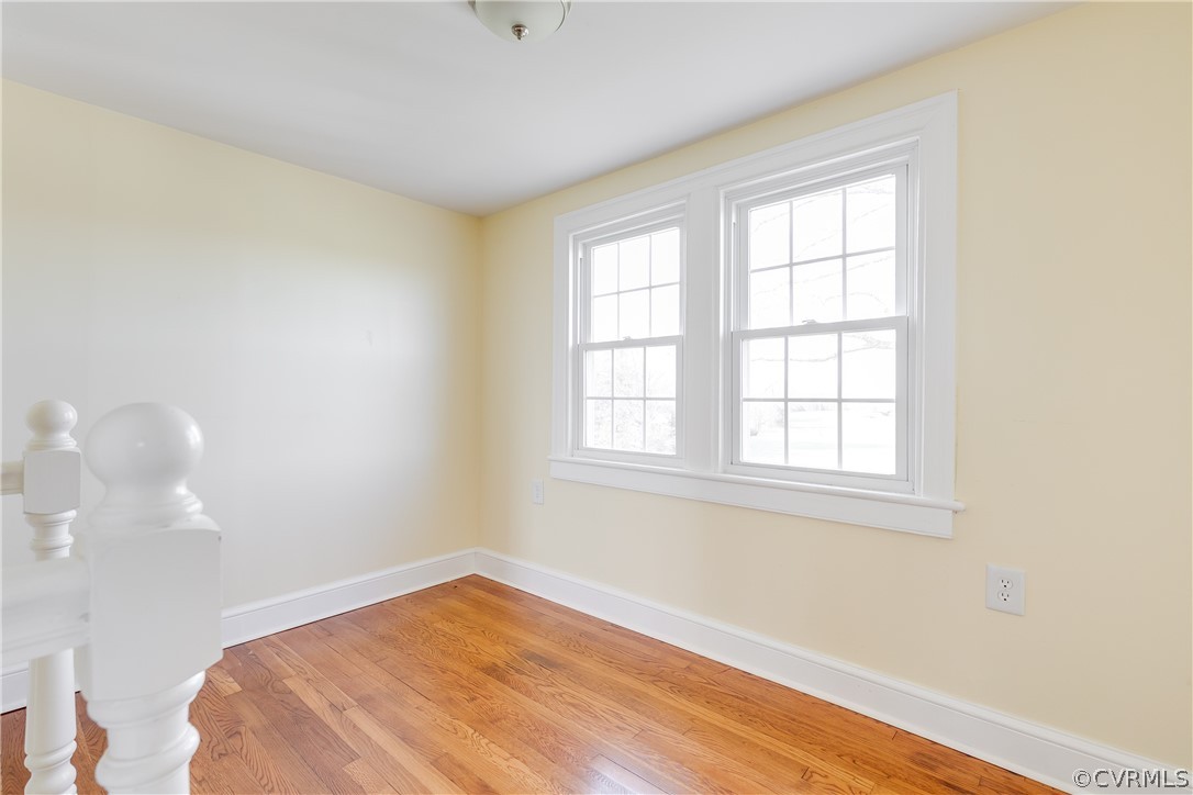 4109 Whitehall Road Sandy Hook, VA 23153 - Photo 19 of 28 an empty room with wooden floor and windows