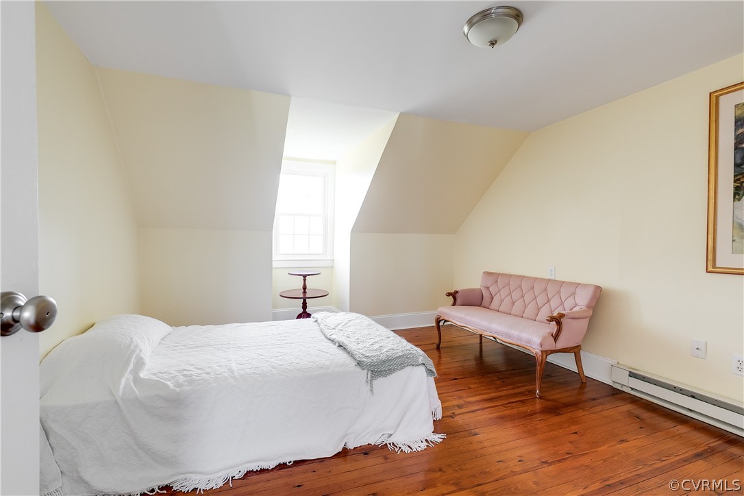 4109 Whitehall Road Sandy Hook, VA 23153 - Photo 20 of 28 a bedroom with a bed and a chair