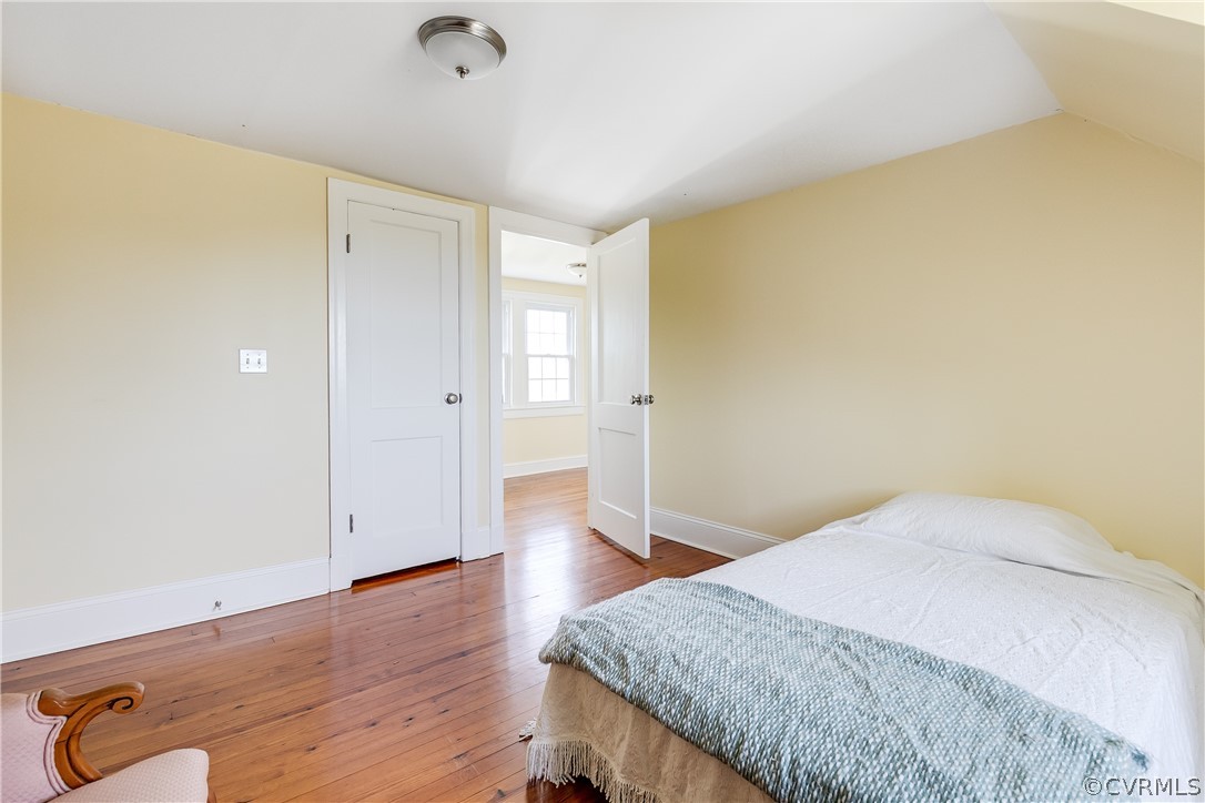 4109 Whitehall Road Sandy Hook, VA 23153 - Photo 21 of 28 a bedroom with a bed and wooden floor