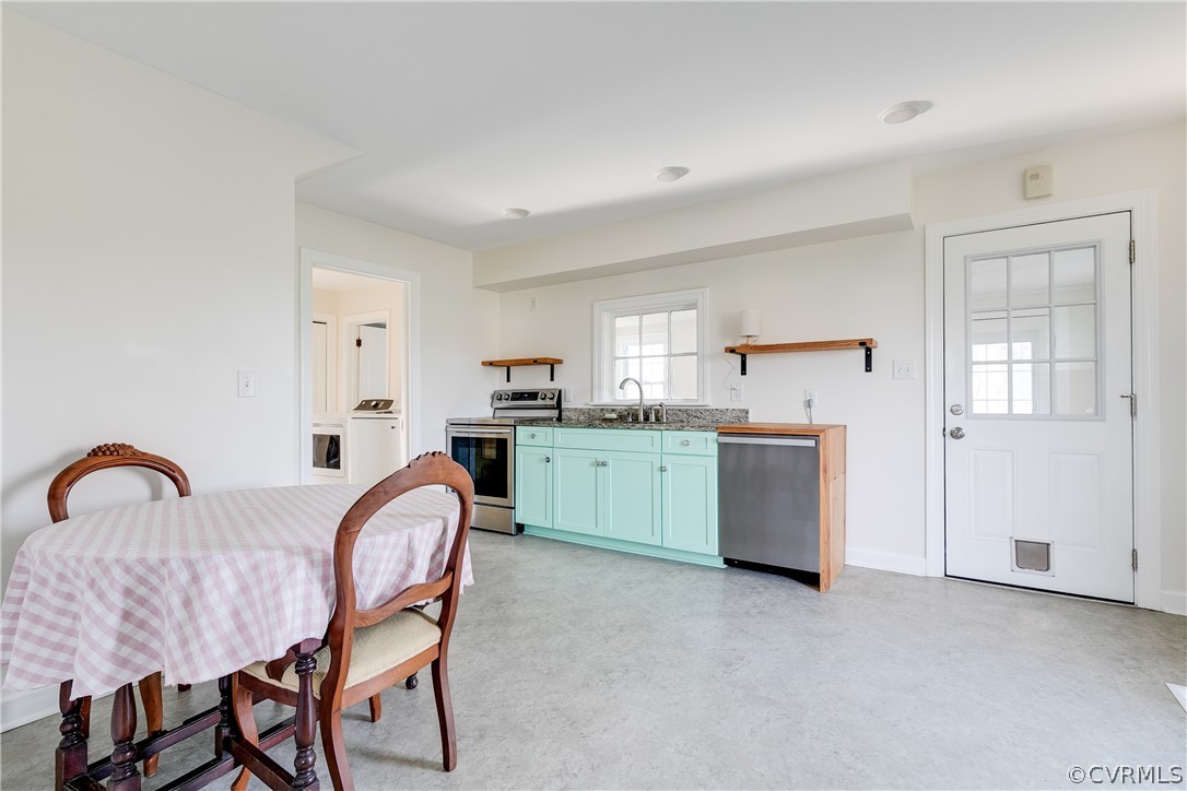 4109 Whitehall Road Sandy Hook, VA 23153 - Photo 6 of 28 a living room with furniture a window and kitchen view