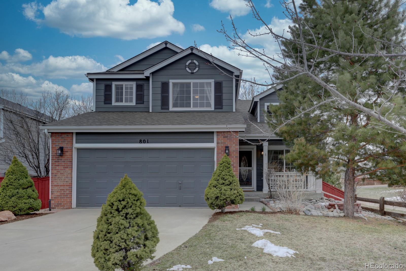 801 Riddlewood Lane Highlands Ranch, CO 80129 - Photo 1 of 40 a front view of a house with garden