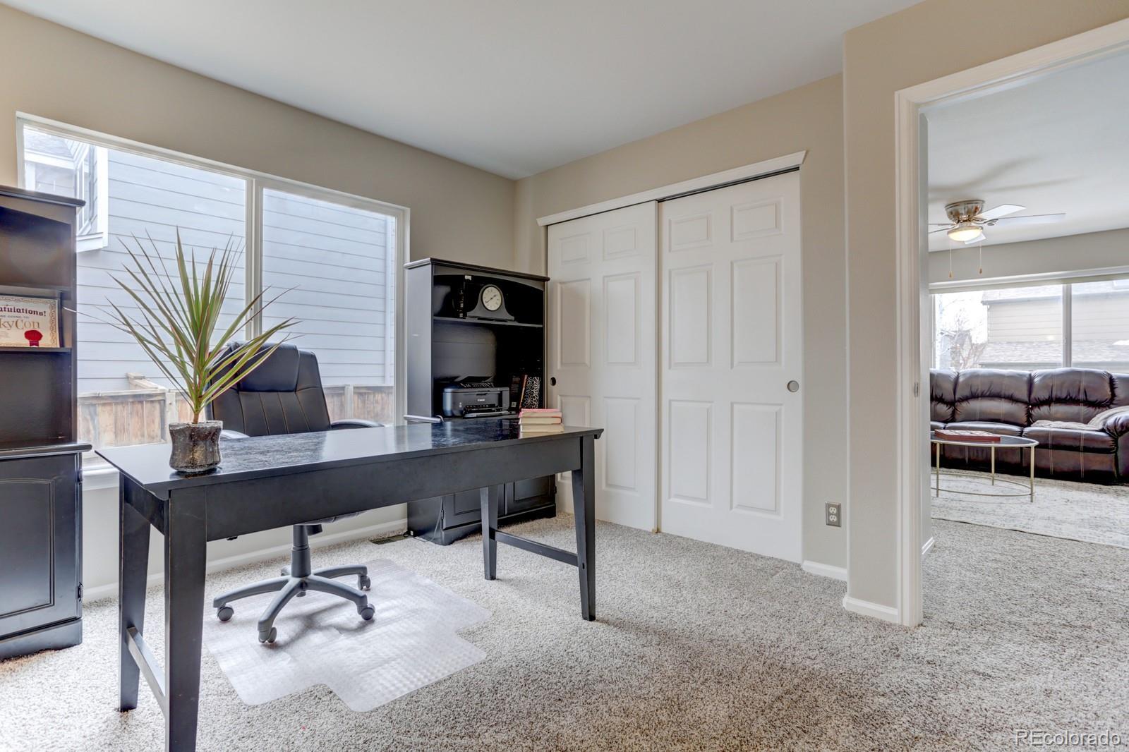801 Riddlewood Lane Highlands Ranch, CO 80129 - Photo 14 of 40 a view of a workspace with a window and potted plant