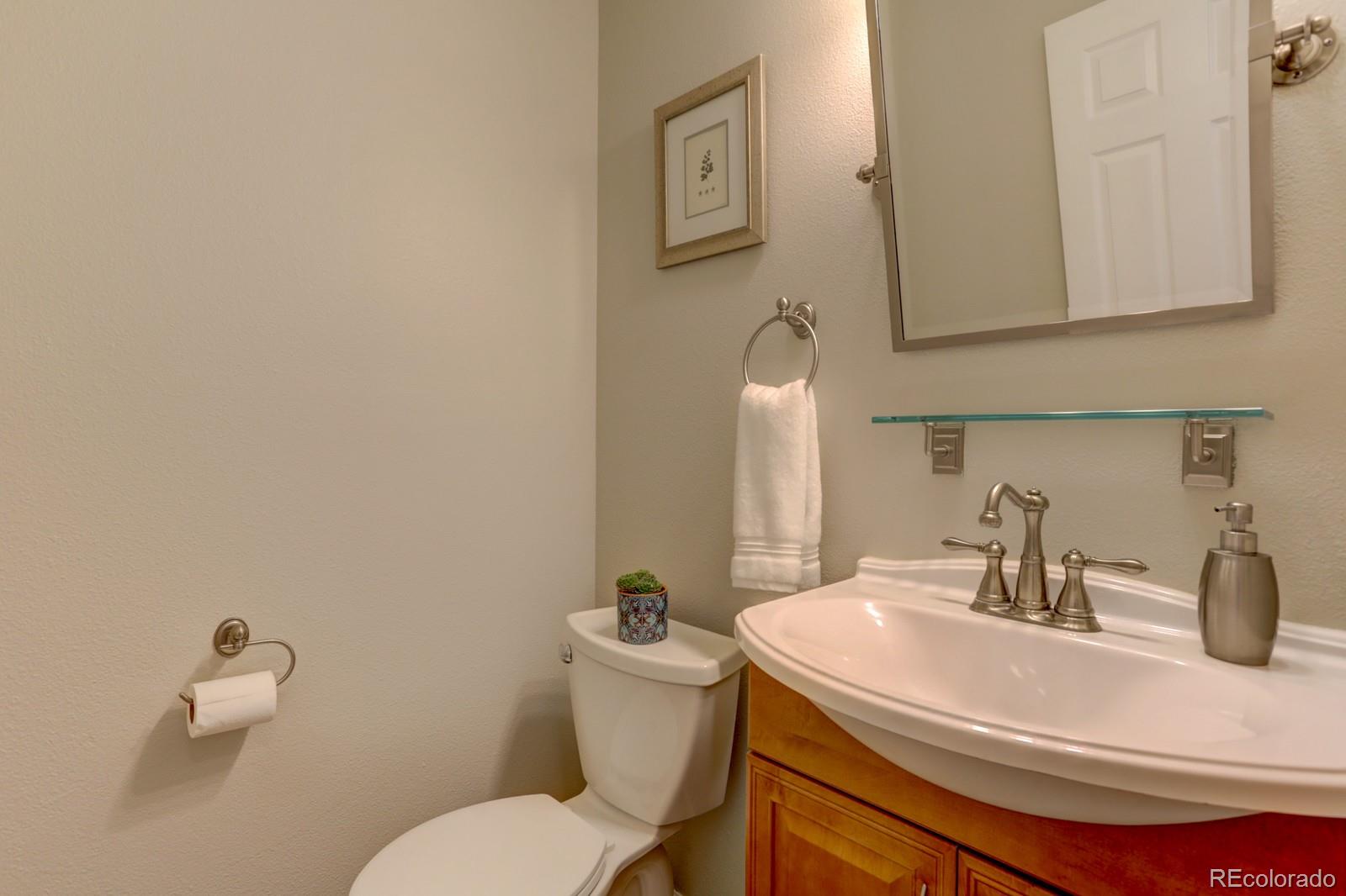 801 Riddlewood Lane Highlands Ranch, CO 80129 - Photo 15 of 40 a bathroom with a sink and a toilet