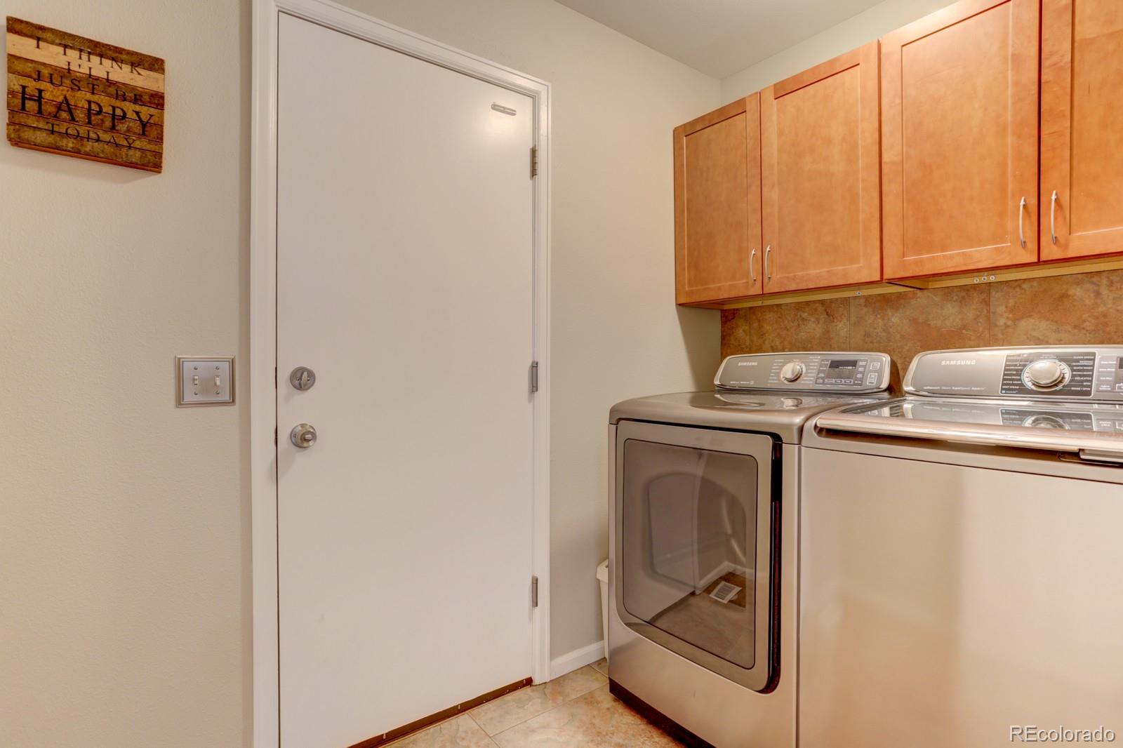 801 Riddlewood Lane Highlands Ranch, CO 80129 - Photo 16 of 40 a utility room with dryer and washer