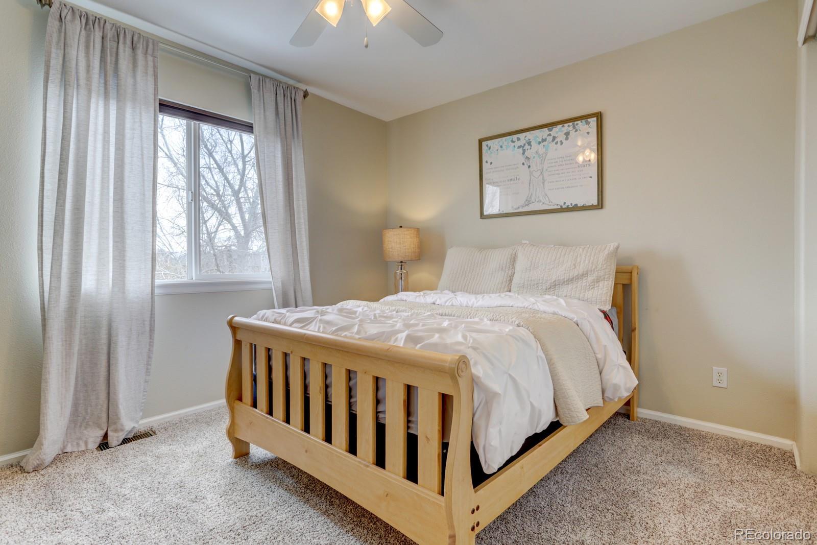 801 Riddlewood Lane Highlands Ranch, CO 80129 - Photo 25 of 40 a bedroom with a bed table and window
