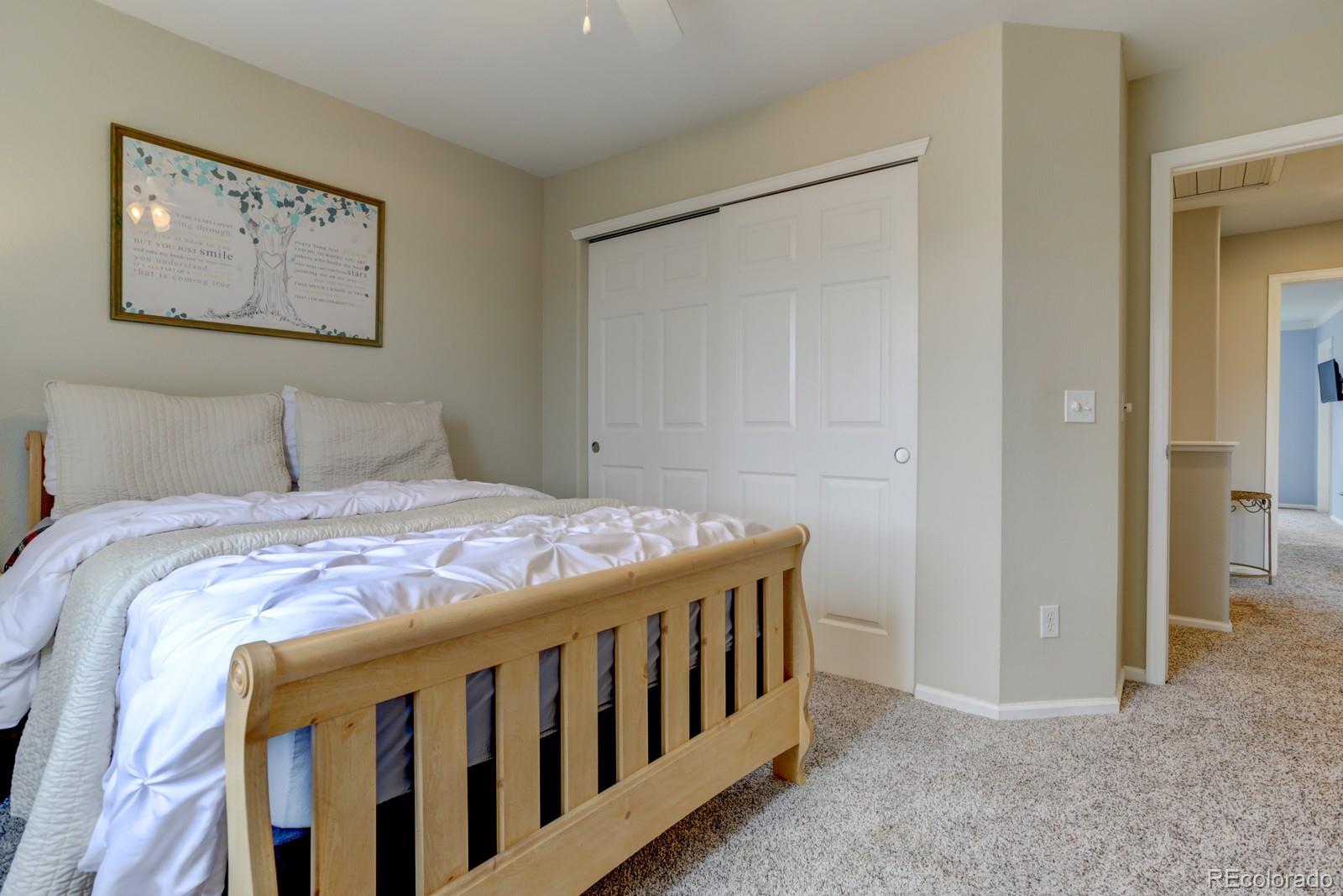801 Riddlewood Lane Highlands Ranch, CO 80129 - Photo 26 of 40 a bedroom with a bed and a bathroom