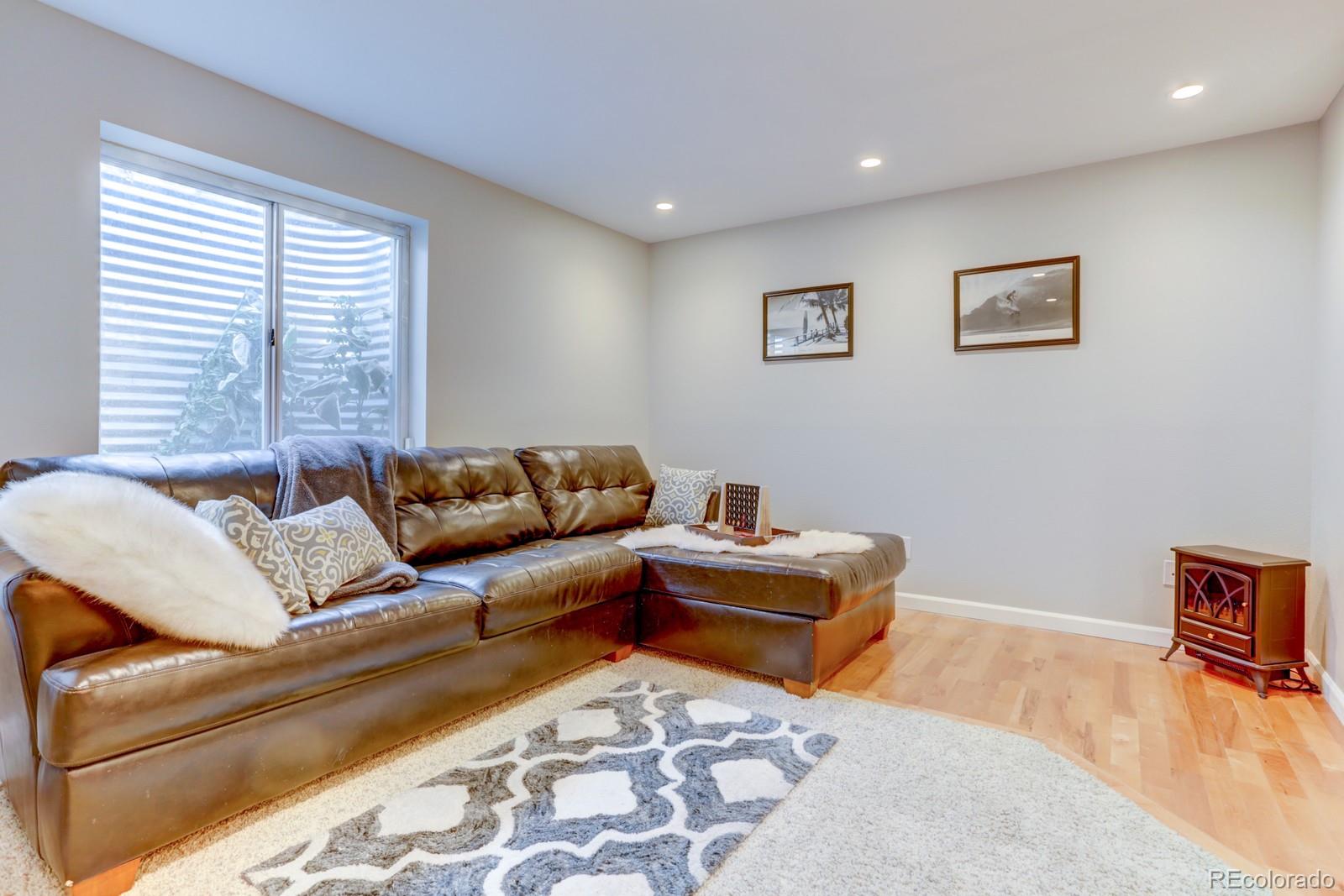 801 Riddlewood Lane Highlands Ranch, CO 80129 - Photo 29 of 40 a living room with furniture and wooden floor