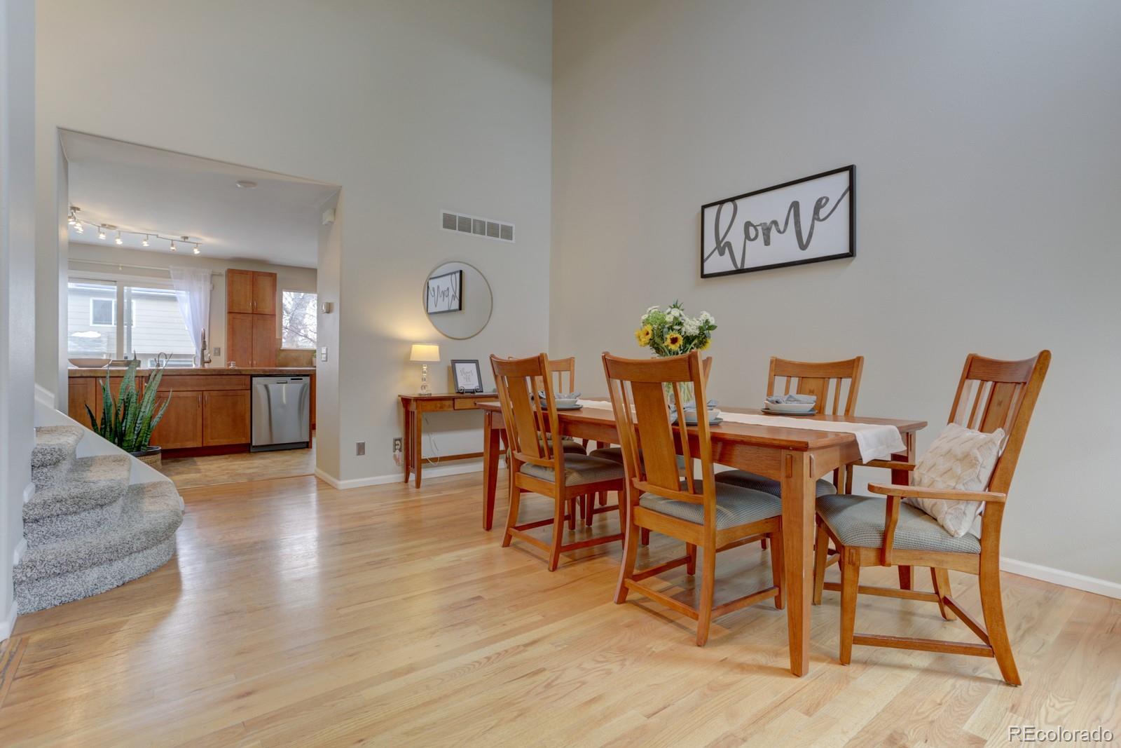 801 Riddlewood Lane Highlands Ranch, CO 80129 - Photo 3 of 40 a dining room with furniture and wooden floor