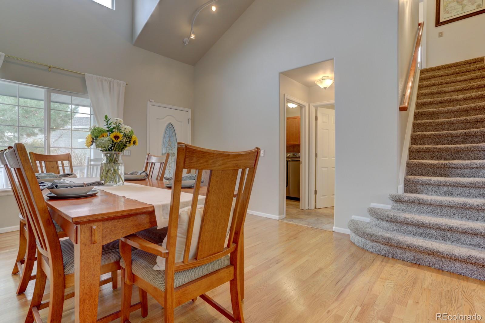 801 Riddlewood Lane Highlands Ranch, CO 80129 - Photo 5 of 40 a dining room with furniture and wooden floor