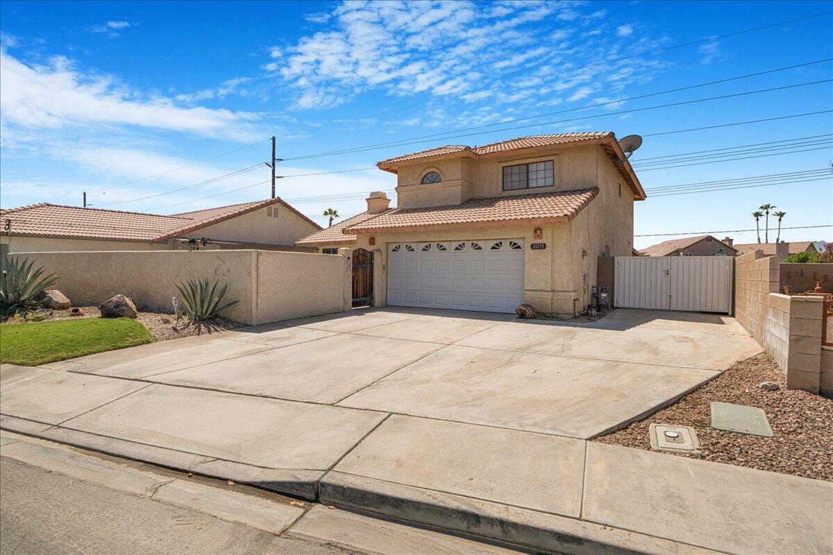 81033 Jamie Way Indio, CA 92201 - Photo 2 of 27 a front view of a house with a garage