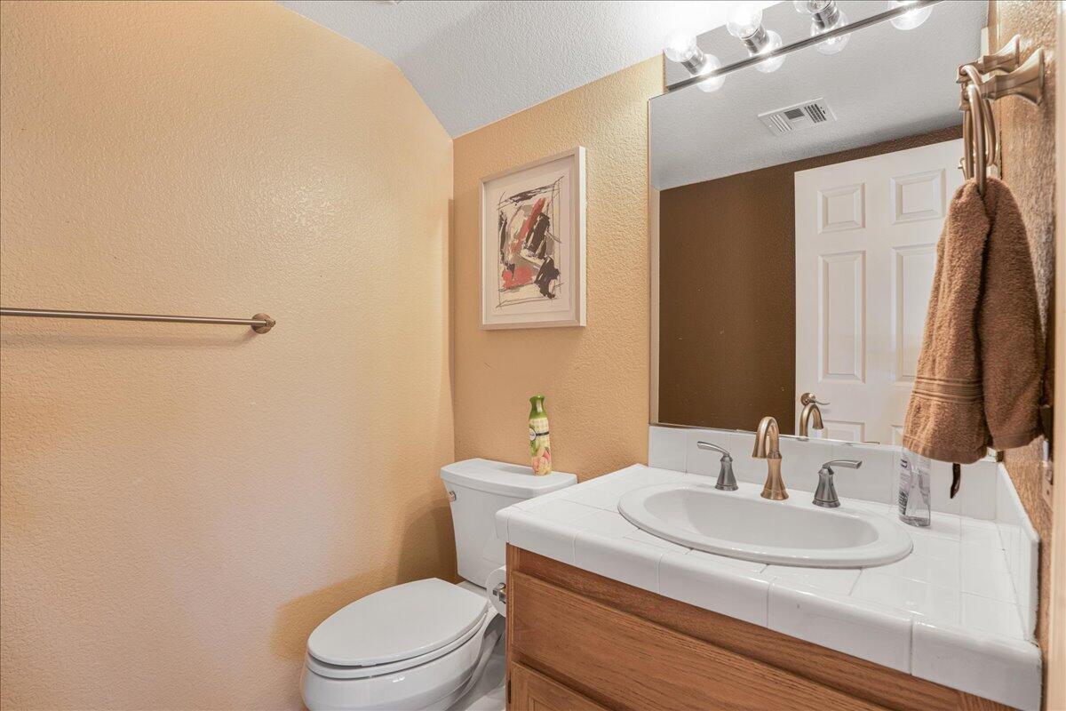 81033 Jamie Way Indio, CA 92201 - Photo 23 of 27 a bathroom with a granite countertop sink toilet and a mirror