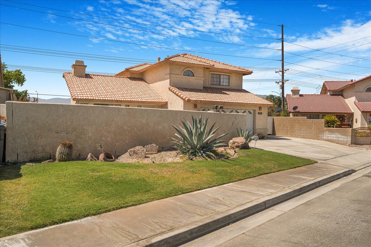 81033 Jamie Way Indio, CA 92201 - Photo 3 of 27 a front view of a house with garden