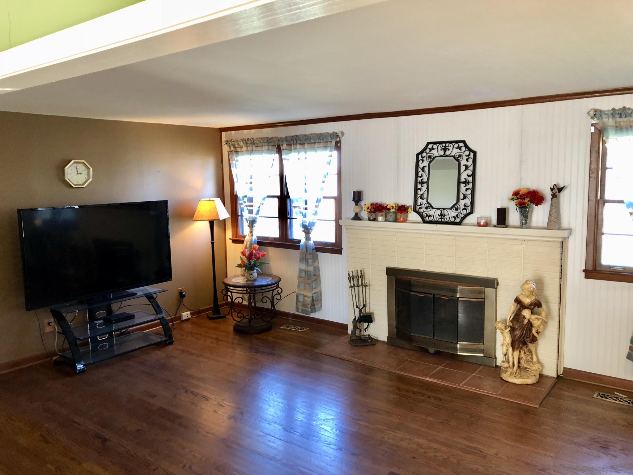 5313 Bluefield Road Knoxville, TN 37921 - Photo 2 of 18 a living room with furniture a fireplace and a flat screen tv