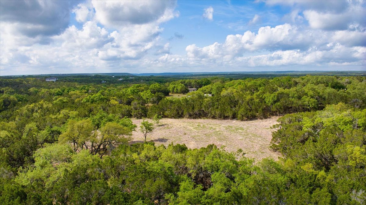 24369 Round Mountain Road, Unit 6 Leander, TX 78641 - Photo 1 of 28 Birds eye view of property featuring a wooded view