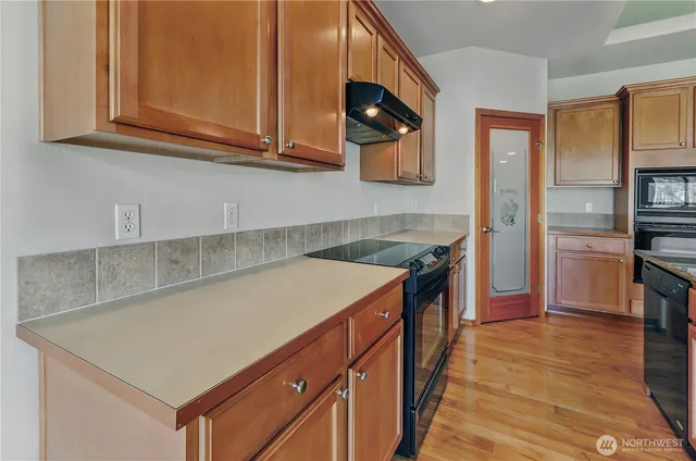 a kitchen with stainless steel appliances granite countertop a sink and a stove