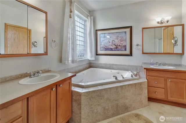 a bathroom with a tub sink and mirror