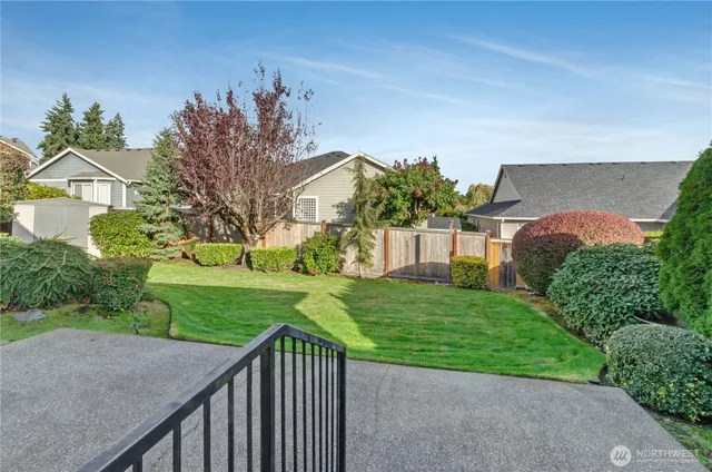 a view of a house with a yard and potted plants