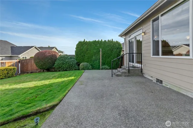 a view of a house with a yard and pathway
