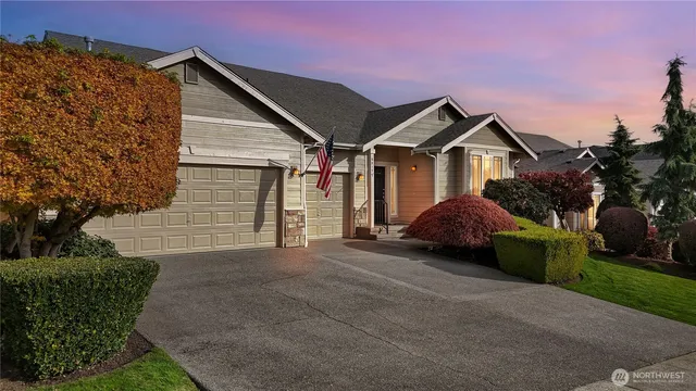 a view of a house with a yard and potted plants