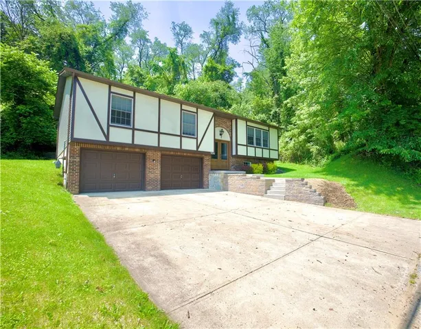 a view of a backyard with a garden and trees