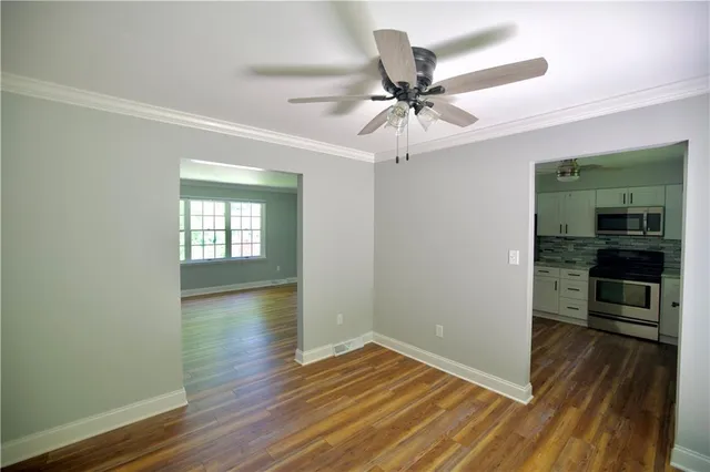 wooden floor in an empty room with a window