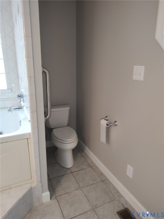 5475 Cold Harbor Road Mechanicsville, VA 23111 - Photo 12 of 29 a white toilet sitting next to a bathroom sink and tub
