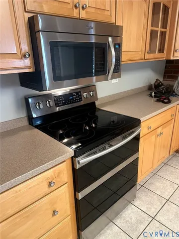 a stove top oven sitting inside of a kitchen