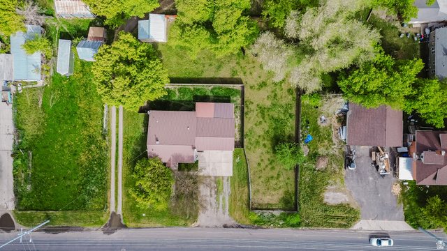 244 North 600 West Logan, UT 84321 - Photo 6 of 30 Property featuring a brown-roofed structure, a paved driveway, a gravel access path, and expansive green spaces