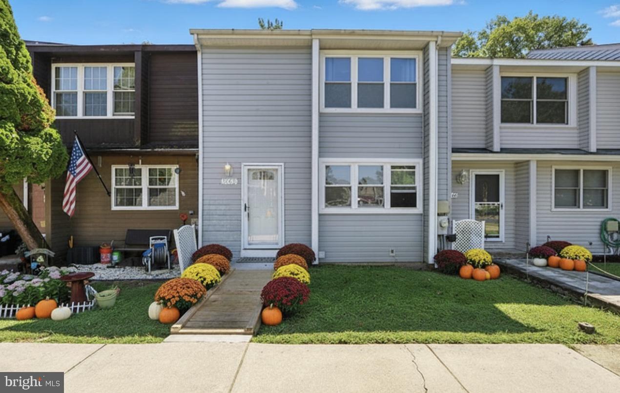 a front view of a house with a garden and plants