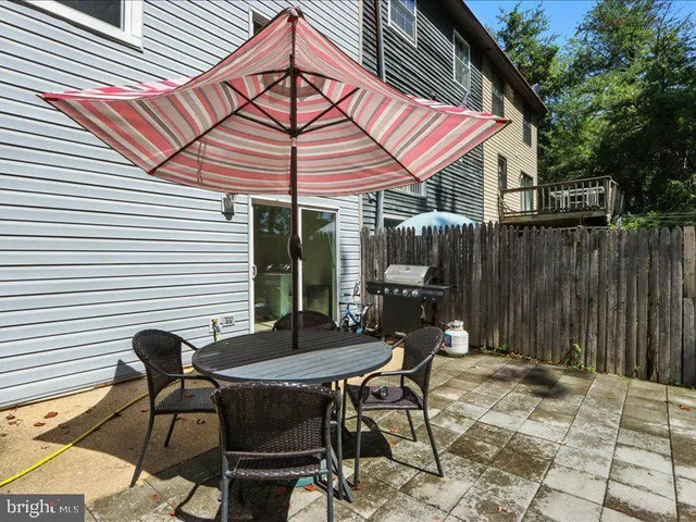 a patio with table and chairs