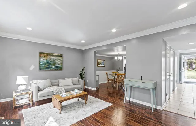 a living room with furniture a rug and a table