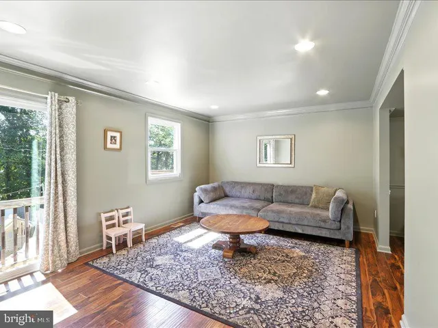 a living room with furniture and a rug