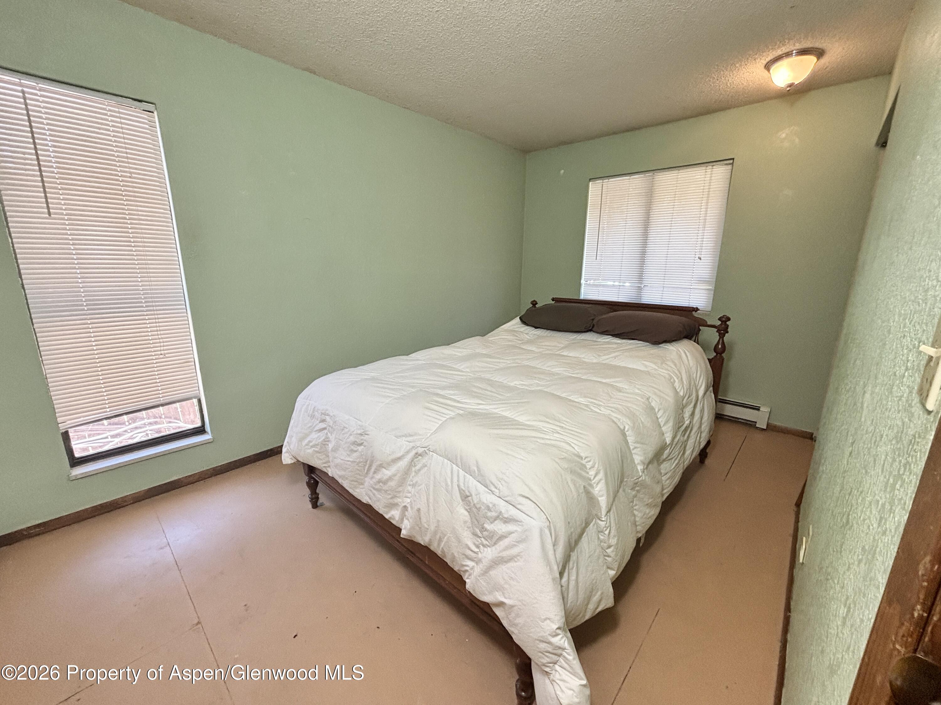 1623 West 7th Street Rifle, CO 81650 - Photo 9 of 21 a bedroom with a bed and a window