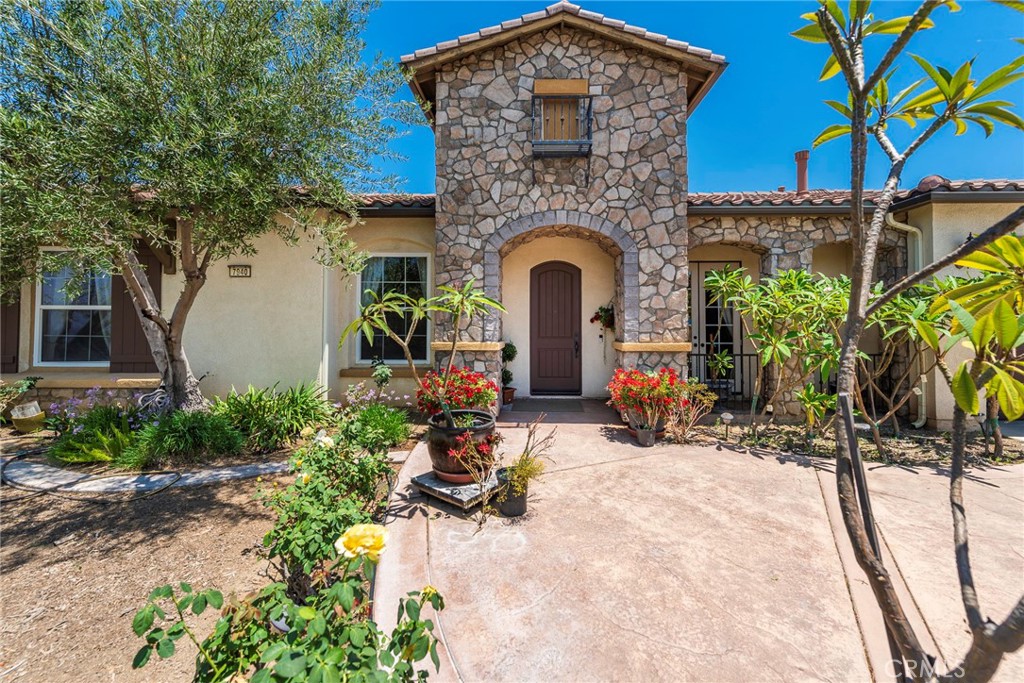 a view of a house with outdoor seating area and potted plants