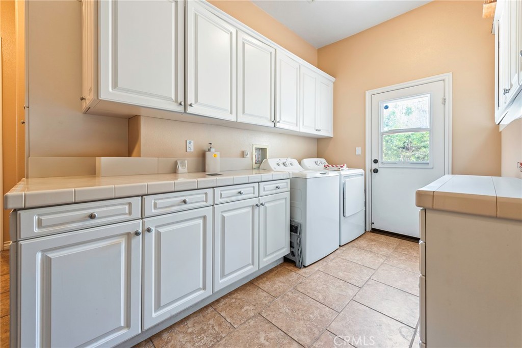 7940 Choi Drive Riverside, CA 92506 - Photo 28 of 56 a kitchen with cabinets appliances a sink and a window