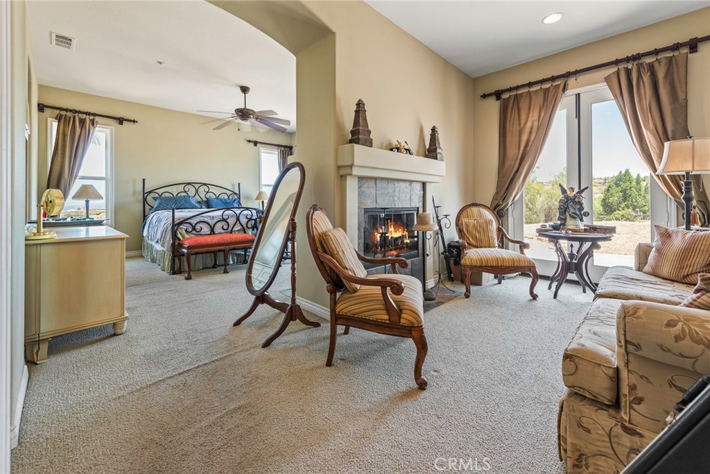 7940 Choi Drive Riverside, CA 92506 - Photo 30 of 56 a living room with furniture a fireplace and large windows