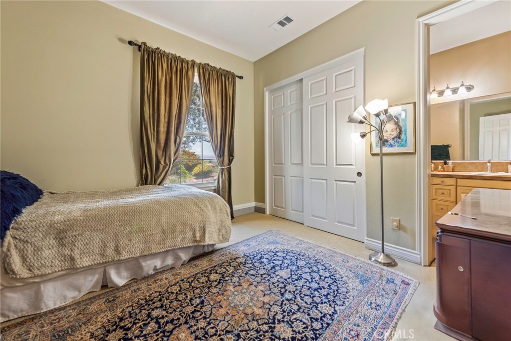 7940 Choi Drive Riverside, CA 92506 - Photo 43 of 56 a bedroom with a bed and a mirror