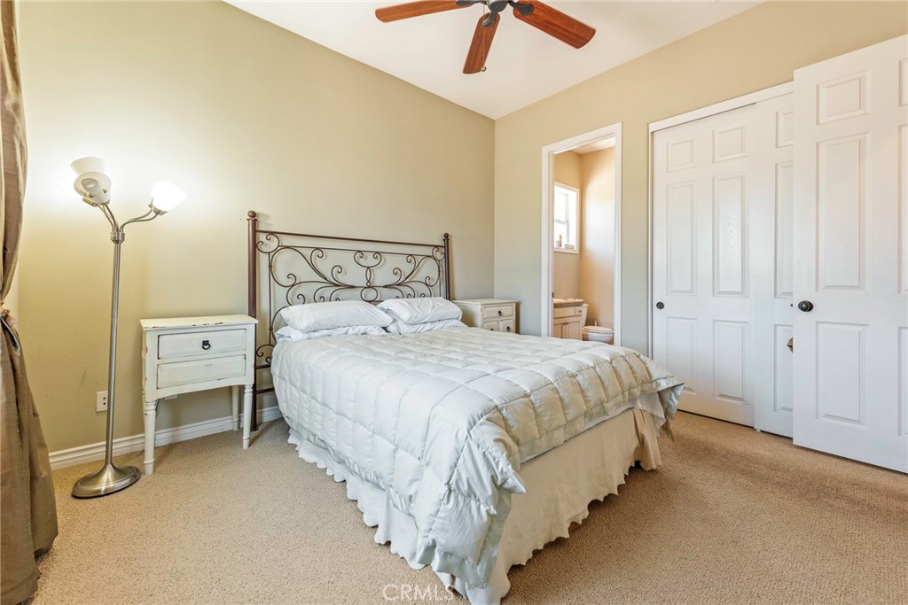 7940 Choi Drive Riverside, CA 92506 - Photo 46 of 56 a spacious bedroom with a bed and a chandelier