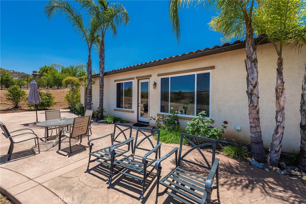 7940 Choi Drive Riverside, CA 92506 - Photo 49 of 56 a view of patio with a table and chairs and potted plants
