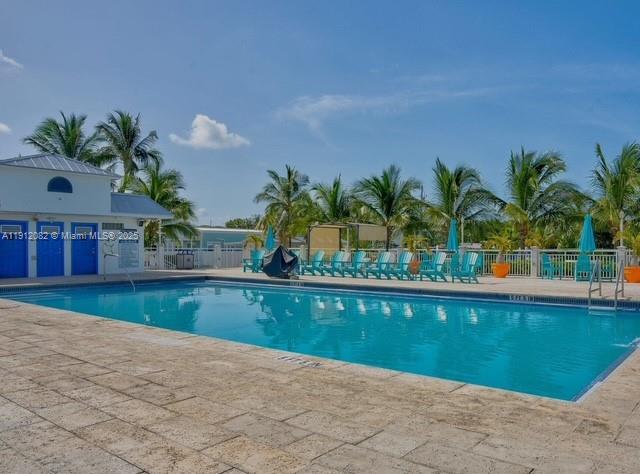 325 Calusa Street, Unit 118 Key Largo, FL 33037 - Photo 12 of 18 a view of a swimming pool and a chair