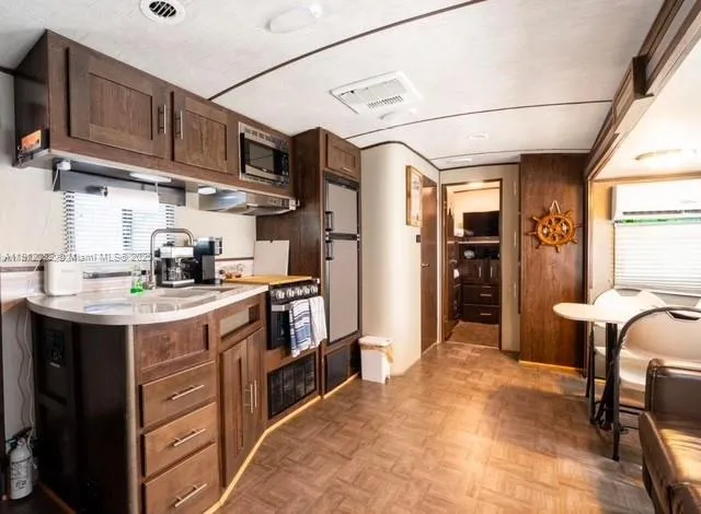 a kitchen with stainless steel appliances granite countertop a sink and cabinets